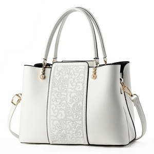 Elegant white crossbody handbag with traditional embroidery and pearl handle details