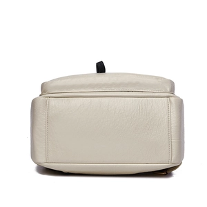 Detailed bottom view of creamy faux leather backpack with refined lychee grain and stitching