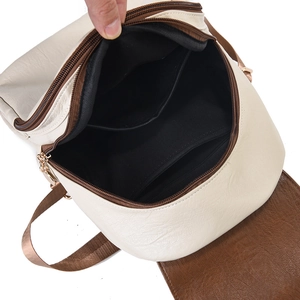 Close-up of the backpack's interior lining with a zipper pocket and open compartment