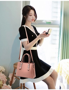 Lifestyle shot of pink pebble leather handbag with silver chain and detachable strap