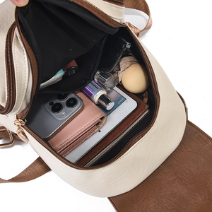 Spacious interior of beige and brown PU leather backpack showing daily essentials storage