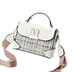 White pebbled leather and tweed crossbody bag with gold rabbit ear clasp and wide strap