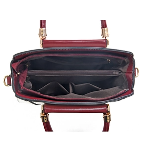Deep red leather handbag interior with multi-layer storage and zipper compartments