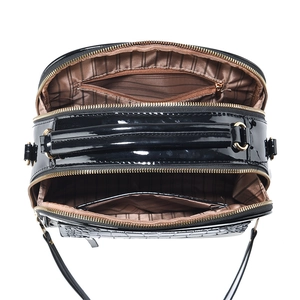 Overhead view of a black patent leather shoulder bag with multiple zippered compartments