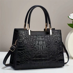 Elegant black faux crocodile skin tote bag with gold hardware and top handles