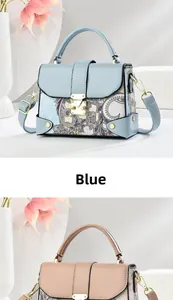 Detail view of printed handbag featuring leather stitching and a metal push-lock closure