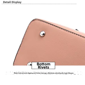 Close-up of metal rivets on the pink leather bag base for wear protection