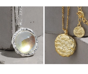 Macro detail of S925 sterling silver stamp on moonstone textured circle pendant