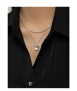 Layered S925 sterling silver necklace with iridescent moonstone pendant on black shirt