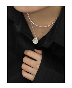Detail of S925 sterling silver layered necklace featuring a round moonstone pendant