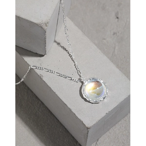 S925 sterling silver necklace featuring an iridescent moonstone pendant on a gray pedestal