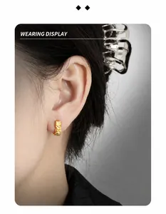 Close-up of S925 silver hoop earring with lava texture worn on ear for minimalist style