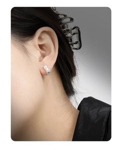 Macro detail of irregular lava texture on S925 sterling silver minimalist ear cuff