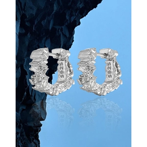 Irregular lava texture S925 sterling silver hoop earrings on natural rock background
