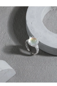 Macro detail of S925 sterling silver ring featuring synthetic moonstone and lava texture
