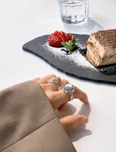 Detail of silver S925 rings featuring irregular hammered texture and grey moonstones