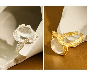 Macro detail of S925 sterling silver rings with lava texture and white crystal stones