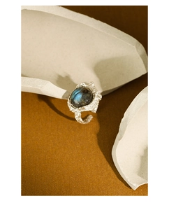 Macro shot of S925 silver open ring with lava texture and iridescent labradorite stone