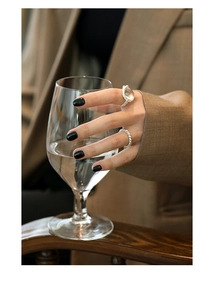 Close-up of S925 silver ring set with white crystal and irregular lava texture detail