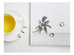 Detailed view of vintage silver hollow twisted rings set on a white cup and magazine
