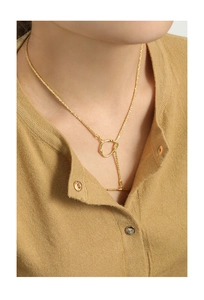 Detail view of S925 silver gold-plated necklace with OT toggle clasp on a beige cardigan