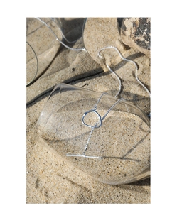 Detailed view of S925 sterling silver necklace with OT clasp on a sunny beach setting
