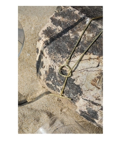 Detail of gold S925 silver star link necklace with OT clasp on a beach rock background