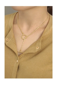 Detail of S925 silver gold necklace with OT toggle clasp on a female model wearing knitwear