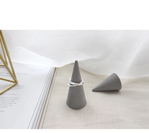 Minimalist S925 sterling silver interlocking double ring displayed on a modern cone stand