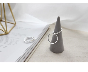 Minimalist S925 sterling silver interlocking rings on a grey cone display