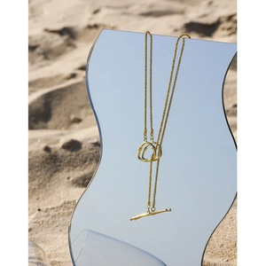 Elegant gold S925 sterling silver star necklace with OT buckle on a beach mirror