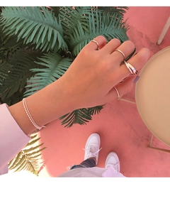 Close-up of S925 sterling silver minimalist rings and beaded bracelet on a woman hand