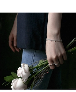 Detailed view of layered S925 sterling silver chain bracelet with beads and twisted rings