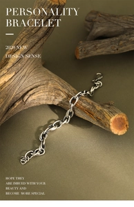 Macro detail of retro S925 sterling silver chain bracelet on a rustic wood branch