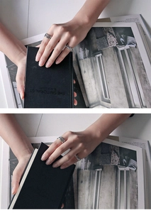 Detail of S925 sterling silver multi-layer wrap rings worn on a hand in a vintage style
