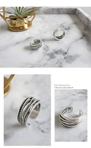 Macro detail of multi-layer braided S925 sterling silver ring with vintage finish and stamp