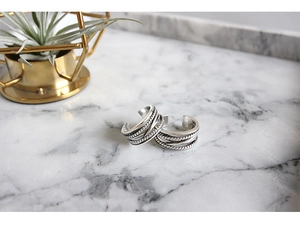 Detailed macro view of S925 sterling silver multilayer twisted rope vintage earrings