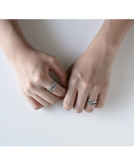 Close-up of S925 sterling silver multi-layer intertwined braided retro open ring on model