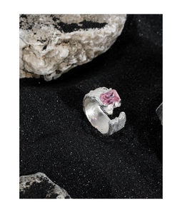 Macro detail of S925 sterling silver ring with lava texture and pink zircon stone