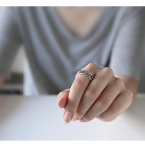 Macro detail of S925 sterling silver multilayer twisted rope open ring for women