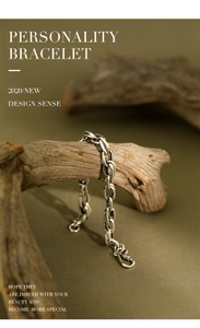 Close-up of S925 sterling silver chain bracelet with vintage finish on driftwood