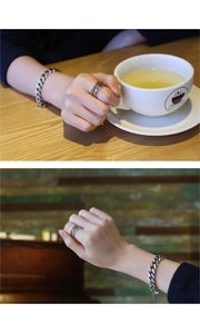 Close-up of vintage S925 sterling silver layered twisted ring and chain bracelet set