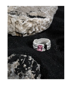 Close-up of S925 sterling silver ring with irregular texture and pink zircon stone