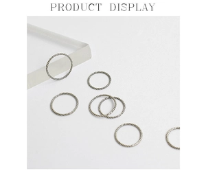Macro view of 925 sterling silver twisted rope rings with vintage finish on acrylic stand