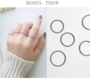Detail view of vintage S925 sterling silver twisted rope rings with woven texture finish