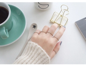 Detail of five-piece minimalist S925 sterling silver thin twisted rope rings on fingers