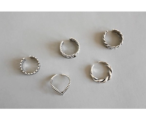 Detail of five vintage silver stackable rings with bohemian engraved textures