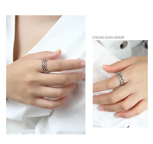 Detail of vintage sterling silver braided chain rings and open scroll pattern bands