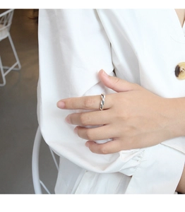 Detail of vintage silver twisted rope ring shown on model finger for daily styling