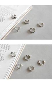 Close-up of vintage Thai silver style rings with braided and twisted engraved textures
